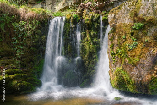 Small waterfall on a mossy wall in a limestone gorge