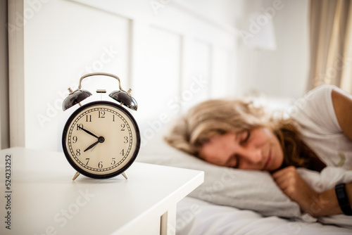 alarm clock and woman sleeping in bed sleep quality