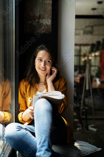  Young businesswoman drinking coffee in her office