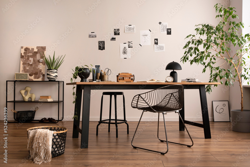 Aesthetic interior of home office interior with design chair, wooden desk,  plants, shelf, office accessories, post cards, photos and decoration.  Minimalist home decor. Template. Stock Photo