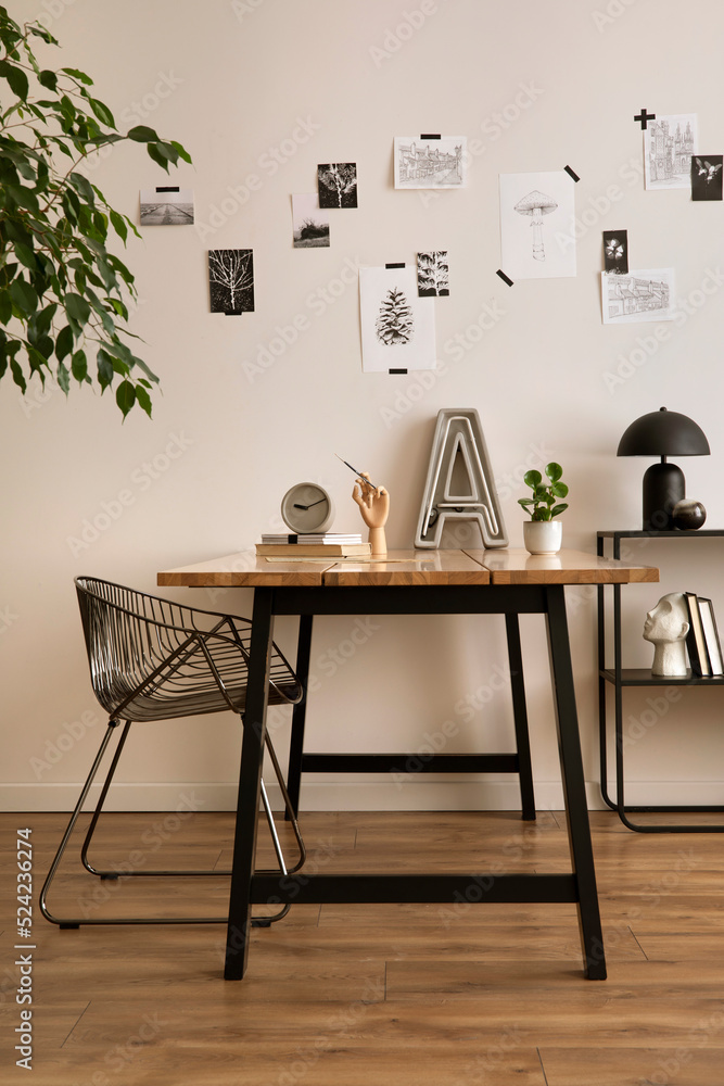 Aesthetic interior of home office interior with design chair, wooden desk,  plants, shelf, office accessories, post cards, photos and decoration.  Minimalist home decor. Template. Stock Photo