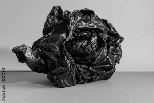 crumpled up black plastic bag monotone