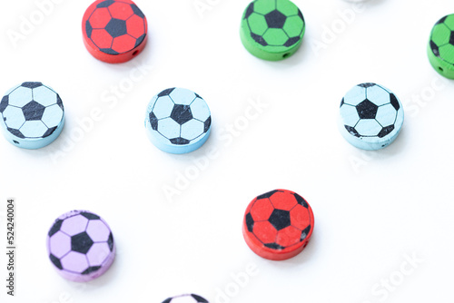 Wooden figures in the form of soccer balls on a white background