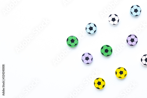 Wooden figures in the form of soccer balls on a white background
