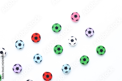 Wooden figures in the form of soccer balls on a white background © ALEXSTUDIO