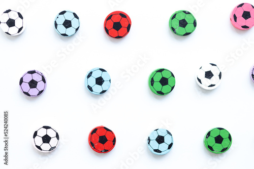 Wooden figures in the form of soccer balls on a white background © ALEXSTUDIO
