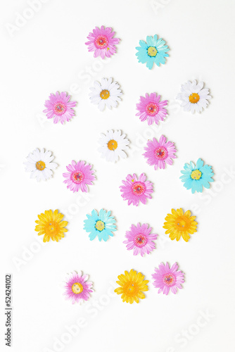 Wooden figures in the form of colored flowers on a white background