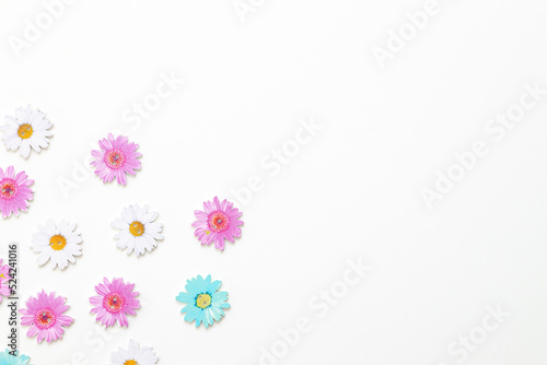 Wooden figures in the form of colored flowers on a white background