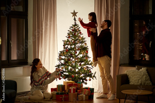Fotografie family, winter holidays and people concept - happy mother, father and little dau