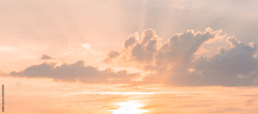 Picture of the clouds in the sunset with orange and yellow colors dominating the atmosphere