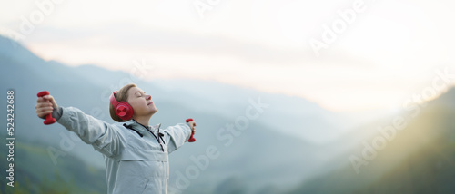 Adult woman listening to music outside