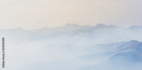 Mountain landscape in the morning with the clouds giving the picture a foggy atmosphere