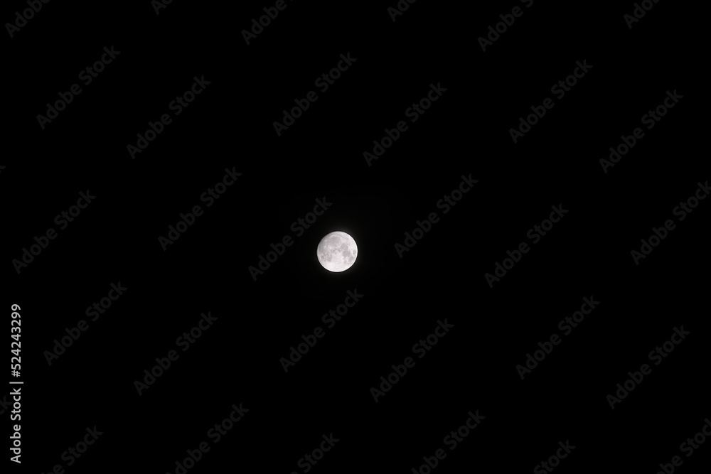moon with visible relief of craters in the night sky moon with visible relief of craters in the night sky