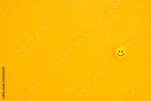 Yellow smile on yellow background