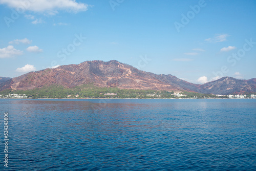 The coast of Turkey near Marmaris city, where the mountains meet the Mediterranean Sea. The shores of Turkey's Mugla province. Mountain hills after big forest fire in 2021