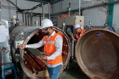 Maintenance mechanical engineer perform boiler spray nozzle leakage check inspectiion at the pressure tank during plant inoperation outage shutdown
