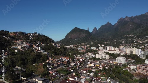 Aerial view of the city of Teresópolis. Mountains and hills with blue sky and many houses in the mountain region of Rio de Janeiro, Brazil. Drone take. Araras, Teresópolis. Sunny day. Sunrise. photo