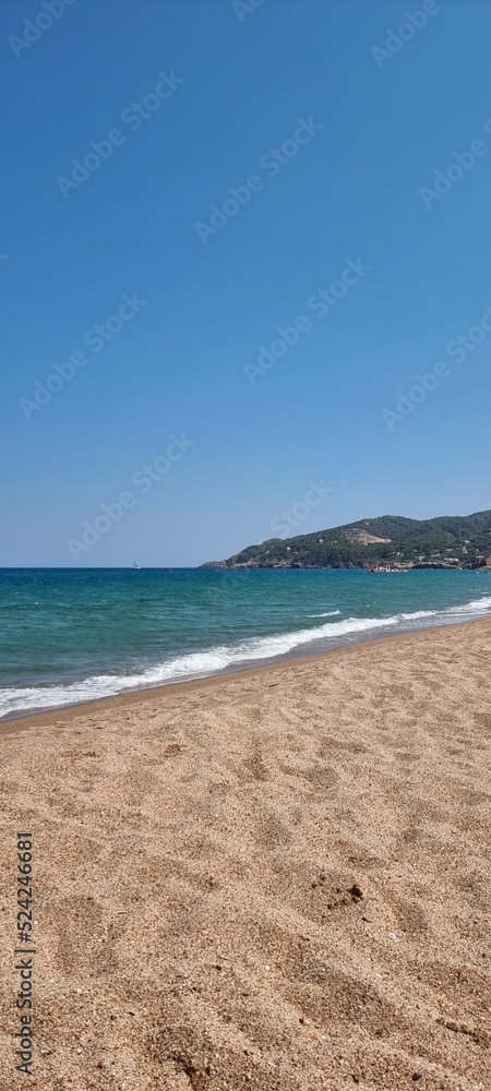 Pals Spain July 2022 lonely beach and the sea against blue sky