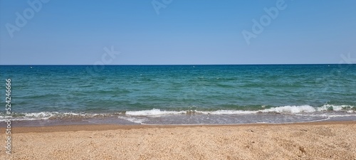 Fototapeta Naklejka Na Ścianę i Meble -  Pals Spain July 2022 lonely beach and the sea against blue sky