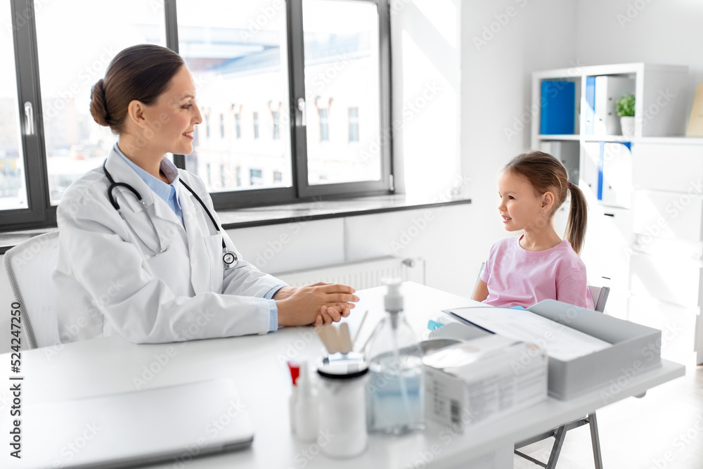 medicine, healthcare and pediatry concept - female doctor or pediatrician talking to happy smiling little girl patient on medical exam at clinic medicine, healthcare and pediatry concept - female doctor or pediatrician talking to happy smiling little girl patient on medical exam at clinic