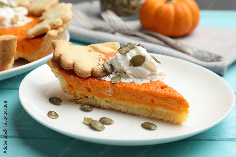 Slice of delicious homemade pumpkin pie on light blue wooden table, closeup Slice of delicious homemade pumpkin pie on light blue wooden table, closeup