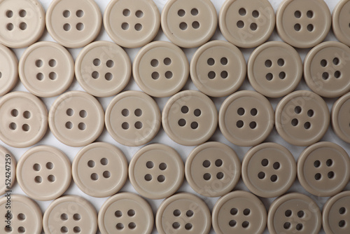 Many plastic sewing buttons on white background  top view