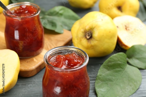 Photographie Delicious quince jam on grey table, closeup