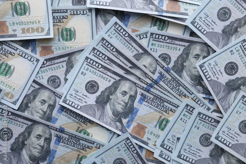 Fototapeta premium Dollar banknotes as background, top view. Money exchange