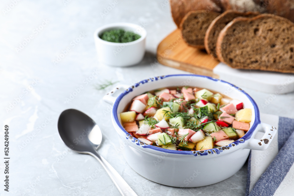 Delicious cold okroshka with kvass served on grey table. Traditional Russian summer soup Delicious cold okroshka with kvass served on grey table. Traditional Russian summer soup