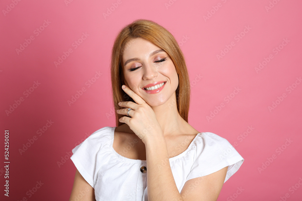 Happy woman with engagement ring on pink background Happy woman with engagement ring on pink background