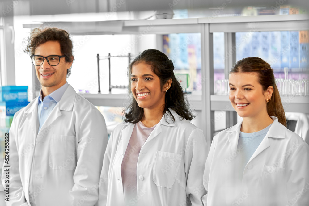 science, work and people concept - international group of happy scientists in laboratory science, work and people concept - international group of happy scientists in laboratory