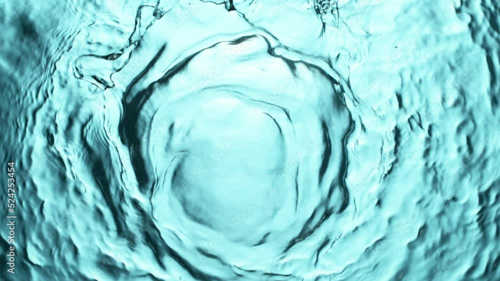 Super slow motion of water surface on light blue background. Filmed on high speed cinema camera, 1000 fps.