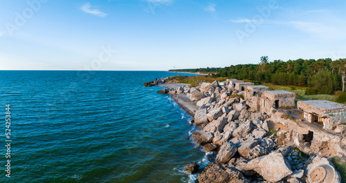 Fototapeta Naklejka Na Ścianę i Meble -  Ruins of bunkers on the beach of the Baltic sea, part of an old fort in the former Soviet base Karosta in Liepaja, Latvia. Sunset landscape.