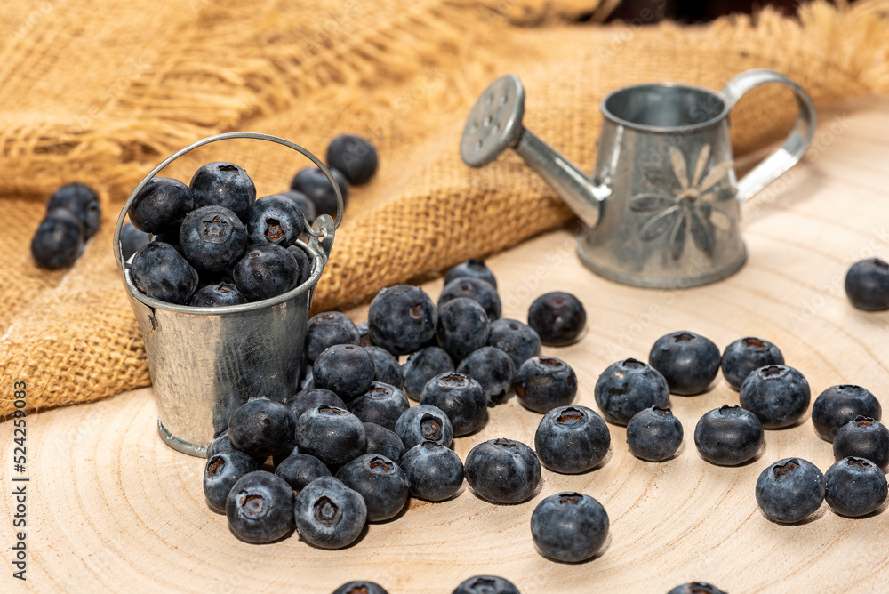 Freshly picked blueberries in wooden bowl. Bilberry on wooden Background. Blueberry antioxidant. Concept for healthy eating and nutrition Freshly picked blueberries in wooden bowl. Bilberry on wooden Background. Blueberry antioxidant. Concept for healthy eating and nutrition