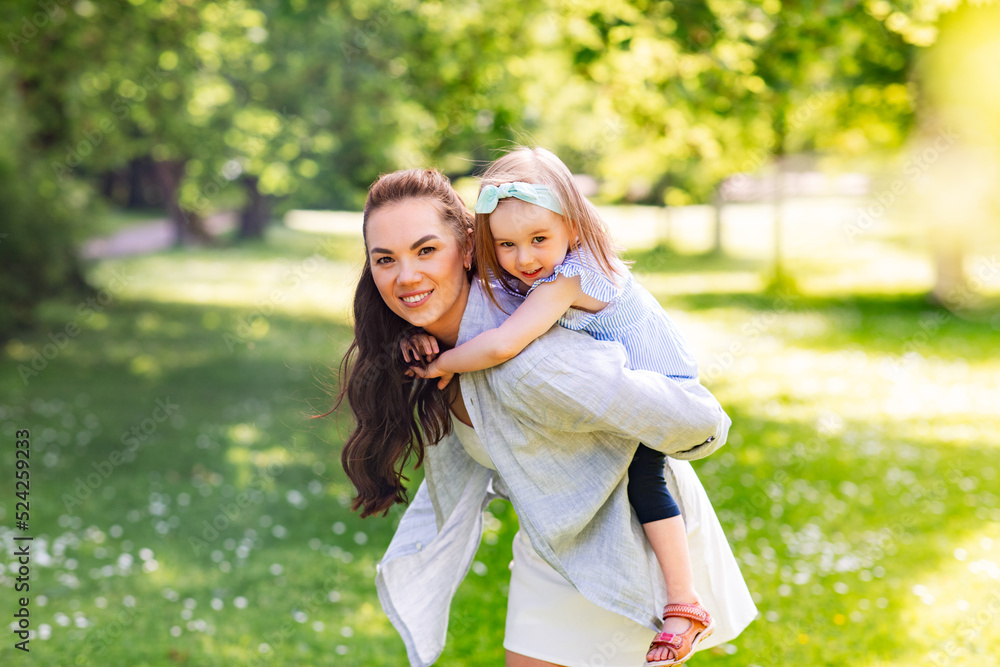 family, motherhood and people concept - happy mother with little daughter having fun at summer park