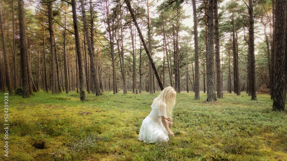 Woman in white dress walking in lush, green forest Woman in white dress walking in lush, green forest