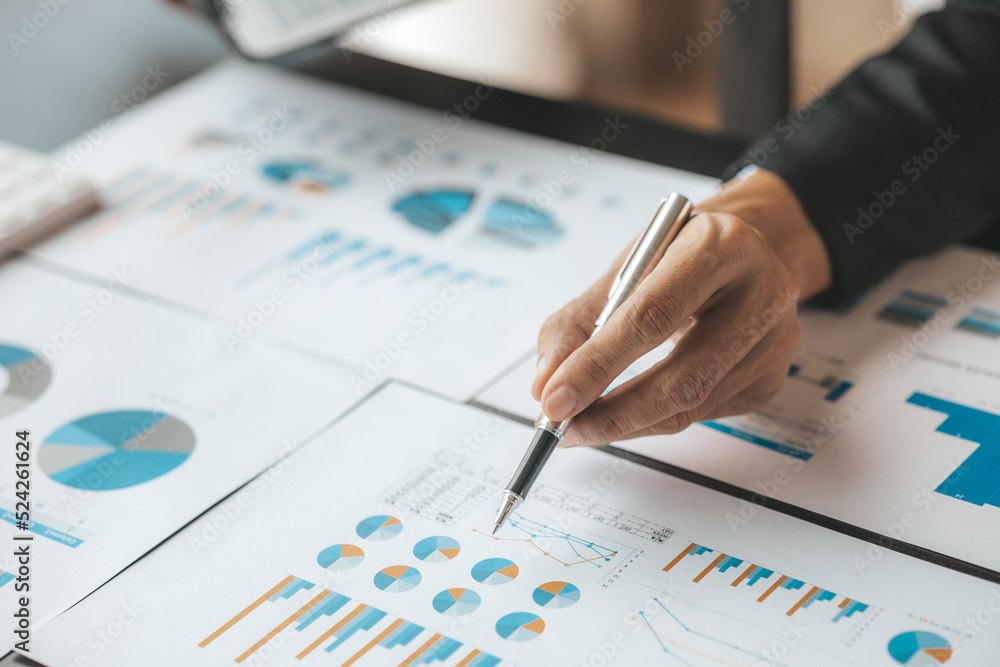 Business men are looking at the company's financial documents to analyze problems and find solutions before bringing the information to a meeting with a partner. Financial concept. Business men are looking at the company's financial documents to analyze problems and find solutions before bringing the information to a meeting with a partner. Financial concept.