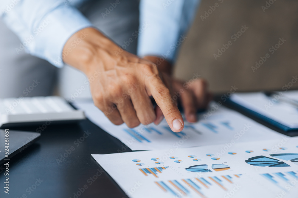 Business men are looking at the company's financial documents to analyze problems and find solutions before bringing the information to a meeting with a partner. Financial concept. Business men are looking at the company's financial documents to analyze problems and find solutions before bringing the information to a meeting with a partner. Financial concept.