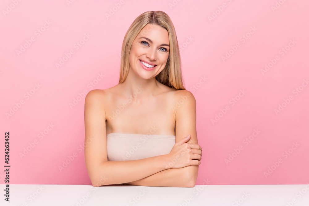 Fototapeta premium Photo of smiling lady sit table wait for daily spa salon routine plastic surgery isolated over pink pastel color background