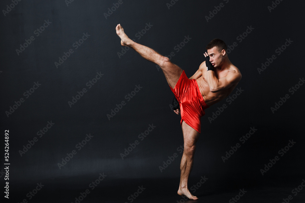 Sportsman muay thai man boxer stance at black background. Sportsman muay thai man boxer stance at black background.