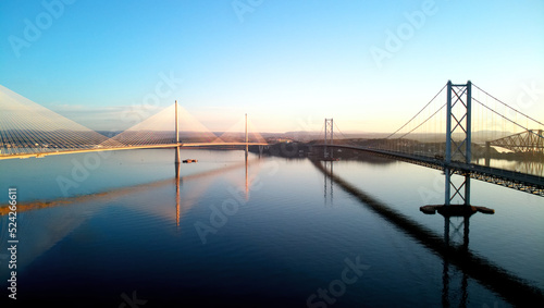 Fototapeta Naklejka Na Ścianę i Meble -  Aerial drone sunrise view of The Queensferry Crossing bridges over the Firth of Forth, Edinburgh, Scotland, UK.