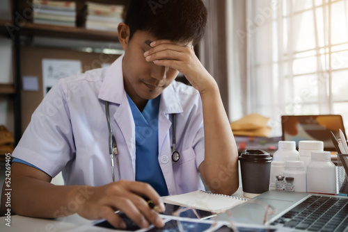 Fotografi Docter eyestrain fatigued from computer work, stressed man suffer from headache bad vision sight problem sit at office table using laptop