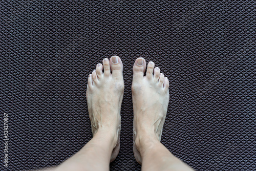 Obraz na płótnie Two legs on anti-slip plastic mat to prevent slip and fall. Rubber flooring for pools and wet rooms. w salonie