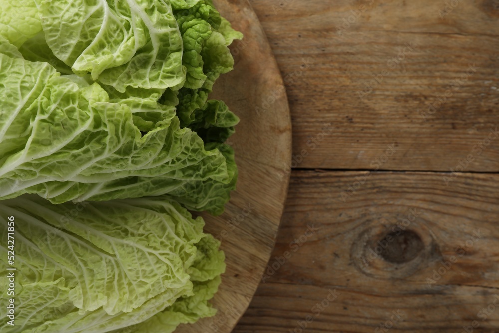 Fresh ripe leaves of Chinese cabbage on wooden table, top view. Space for text Fresh ripe leaves of Chinese cabbage on wooden table, top view. Space for text