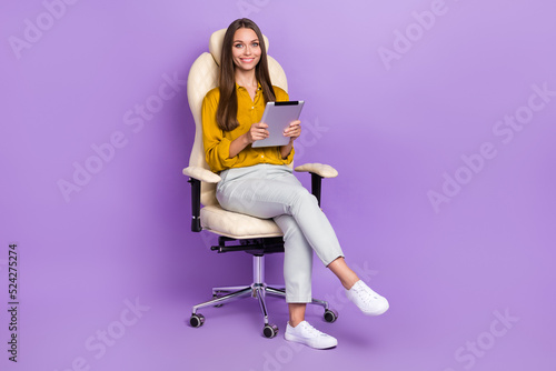 Fototapeta Naklejka Na Ścianę i Meble -  Full size photo of lady type tablet wear blouse trousers shoes isolated on purple color background