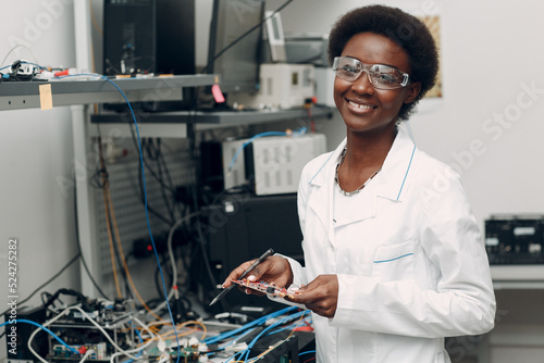 Scientist african american woman working in laboratory with electronic tech instruments. Research and development of electronic devices by color black woman.