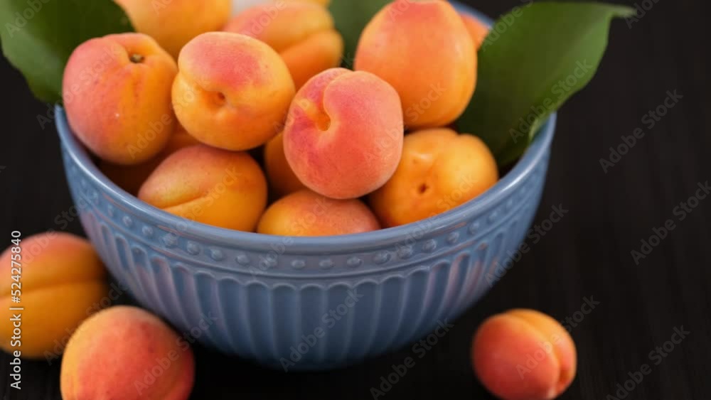 Organic apricots in a bowl. Low key. Close up. Organic apricots in a bowl. Low key. Close up.