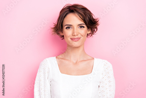 Photo portrait of lovely cute young girl smiling shopping banner promoter dressed trendy white outfit isolated on pink color background