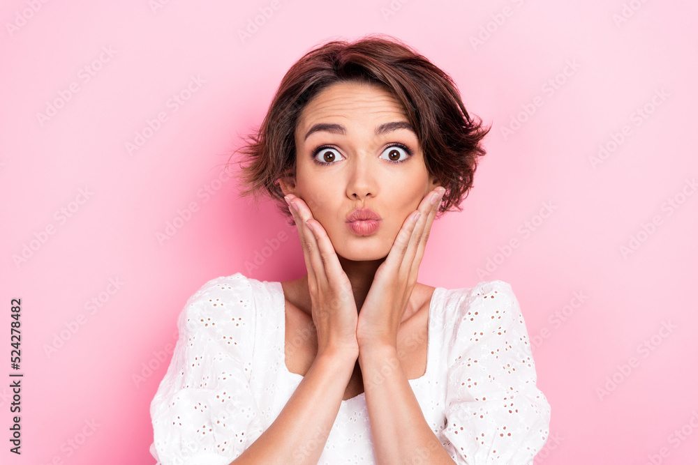 Photo portrait of cute young woman impressed palms touch face pouted lips dressed trendy white outfit isolated on pink color background Photo portrait of cute young woman impressed palms touch face pouted lips dressed trendy white outfit isolated on pink color background