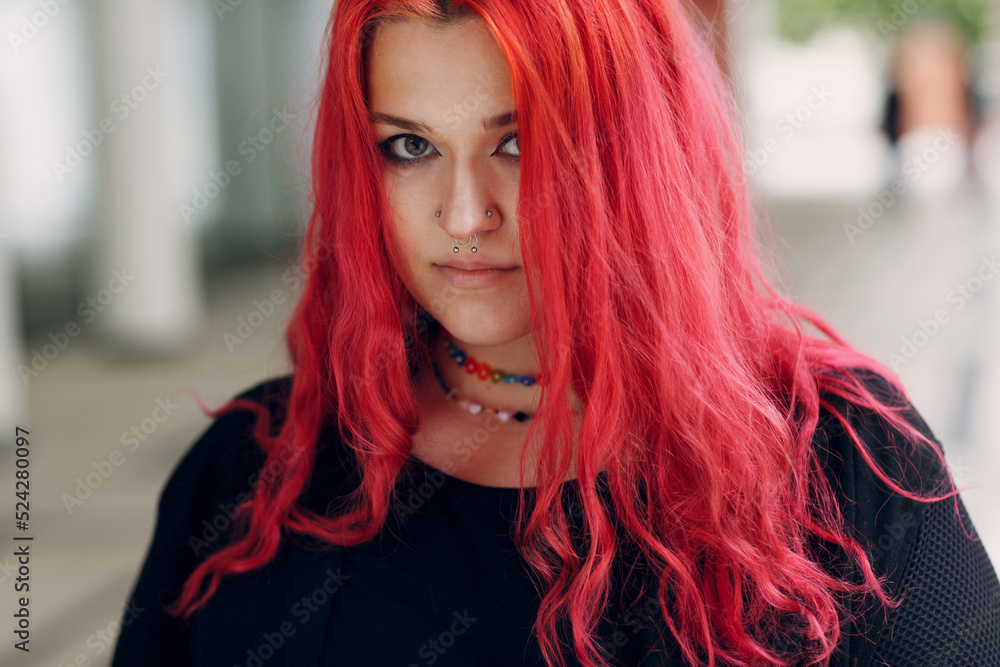 European plus size woman portrait outdoor street city. Young red pink haired body positive girl. European plus size woman portrait outdoor street city. Young red pink haired body positive girl.